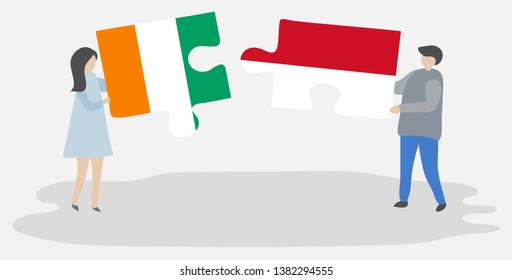 Couple holding two puzzles pieces with Ivorian and Indonesian flags. Ivory Coast and Indonesia national symbols together.