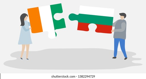 Couple holding two puzzles pieces with Ivorian and Bulgarian flags. Ivory Coast and Bulgaria national symbols together.