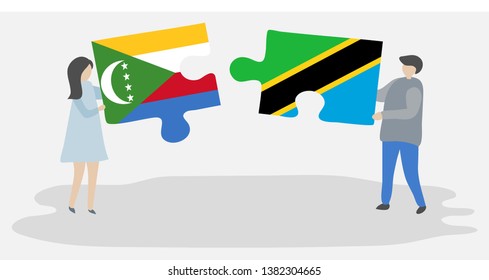 Couple holding two puzzles pieces with Comoran and Tanzanian flags. Comoros and Tanzania national symbols together.