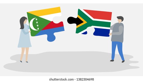 Couple holding two puzzles pieces with Comoran and South African flags. Comoros and South Africa national symbols together.