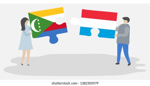 Couple holding two puzzles pieces with Comoran and Luxembourgish flags. Comoros and Luxembourg national symbols together.