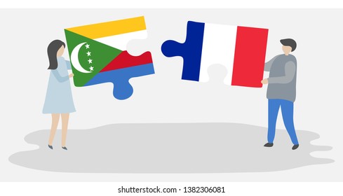 Couple holding two puzzles pieces with Comoran and French flags. Comoros and France national symbols together.