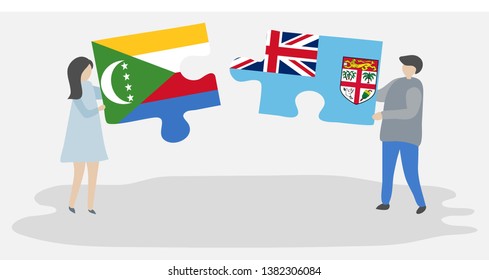 Couple holding two puzzles pieces with Comoran and Fijian flags. Comoros and Fiji national symbols together.
