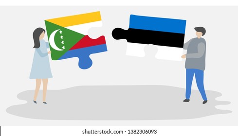 Couple holding two puzzles pieces with Comoran and Estonian flags. Comoros and Estonia national symbols together.