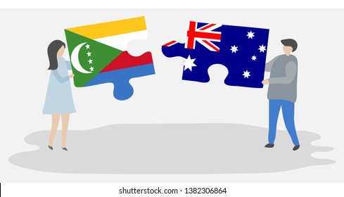 Couple holding two puzzles pieces with Comoran and Australian flags. Comoros and Australia national symbols together.