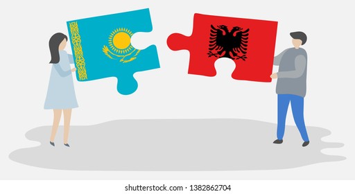 Couple holding two puzzles pieces with Kazakh and Albanian flags. Kazakhstan and Albania national symbols together.