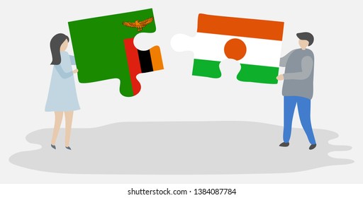 Couple holding two puzzles pieces with Zambian and Nigerien flags. Zambia and Niger national symbols together.