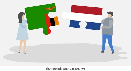 Couple holding two puzzles pieces with Zambian and Dutch flags. Zambia and Netherlands national symbols together.