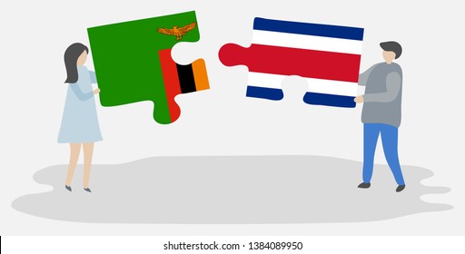 Couple holding two puzzles pieces with Zambian and Costa Rican flags. Zambia and Costa Rica national symbols together.