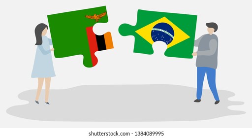 Couple holding two puzzles pieces with Zambian and Brazilian flags. Zambia and Brazil national symbols together.