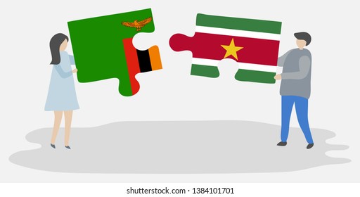 Couple holding two puzzles pieces with Zambian and Surinamese flags. Zambia and Suriname national symbols together.