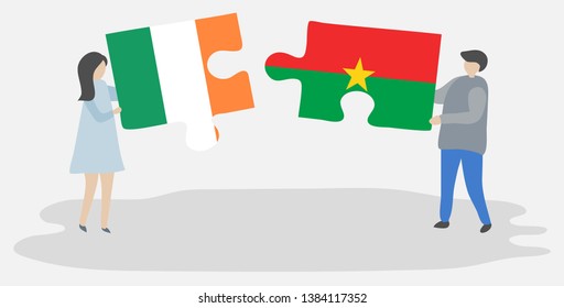 Couple holding two puzzles pieces with Irish and Burkinabe flags. Ireland and Burkina Faso national symbols together.