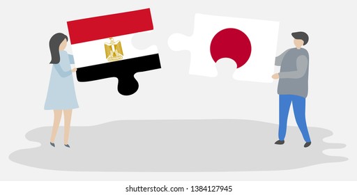 Couple holding two puzzles pieces with Egyptian and Japanese flags. Egypt and Japan national symbols together.