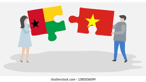 Couple holding two puzzles pieces with Bissau-Guinean and Vietnamese flags. Guinea-Bissau and Vietnam national symbols together.