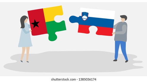 Couple holding two puzzles pieces with Bissau-Guinean and Slovenian flags. Guinea-Bissau and Slovenia national symbols together.