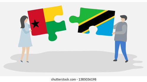 Couple holding two puzzles pieces with Bissau-Guinean and Tanzanian flags. Guinea-Bissau and Tanzania national symbols together.