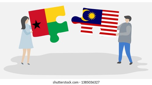 Couple holding two puzzles pieces with Bissau-Guinean and Malaysian flags. Guinea-Bissau and Malaysia national symbols together.