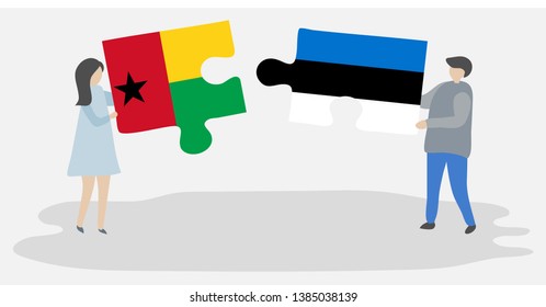 Couple holding two puzzles pieces with Bissau-Guinean and Estonian flags. Guinea-Bissau and Estonia national symbols together.