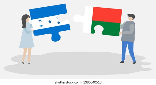 Couple holding two puzzles pieces with Honduran and Malagasy flags. Honduras and Madagascar national symbols together.