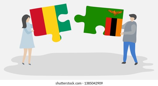 Couple holding two puzzles pieces with Guinean and Zambian flags. Guinea and Zambia national symbols together.