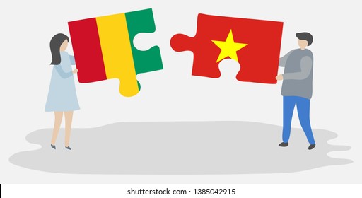 Couple holding two puzzles pieces with Guinean and Vietnamese flags. Guinea and Vietnam national symbols together.