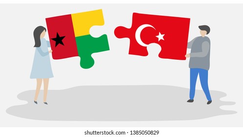 Couple holding two puzzles pieces with Bissau-Guinean and Turkish flags. Guinea-Bissau and Turkey national symbols together.