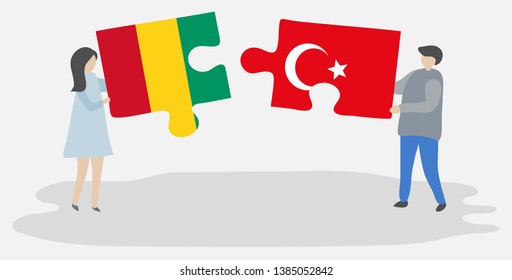 Couple holding two puzzles pieces with Guinean and Turkish flags. Guinea and Turkey national symbols together.
