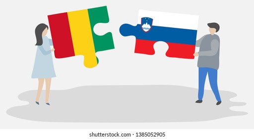 Couple holding two puzzles pieces with Guinean and Slovenian flags. Guinea and Slovenia national symbols together.