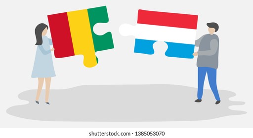 Couple holding two puzzles pieces with Guinean and Luxembourgish flags. Guinea and Luxembourg national symbols together.