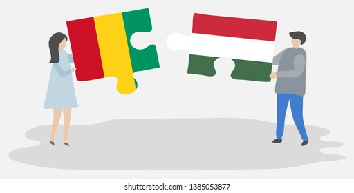 Couple holding two puzzles pieces with Guinean and Hungarian flags. Guinea and Hungary national symbols together.