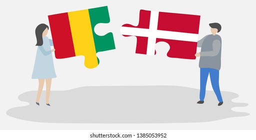 Couple holding two puzzles pieces with Guinean and Danish flags. Guinea and Denmark national symbols together.