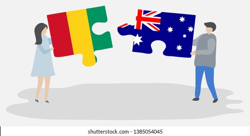 Couple holding two puzzles pieces with Guinean and Australian flags. Guinea and Australia national symbols together.