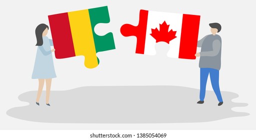 Couple holding two puzzles pieces with Guinean and Canadian flags. Guinea and Canada national symbols together.