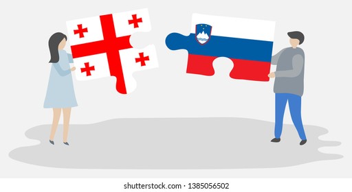 Couple holding two puzzles pieces with Georgian and Slovenian flags. Georgia and Slovenia national symbols together.