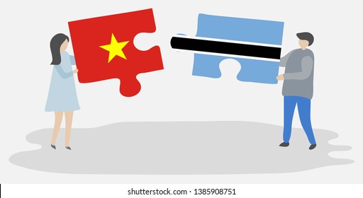 Couple holding two puzzles pieces with Vietnamese and Motswana flags. Vietnam and Botswana national symbols together.