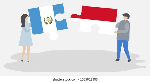Couple holding two puzzles pieces with Guatemalan and Indonesian flags. Guatemala and Indonesia national symbols together.