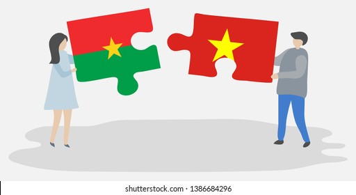 Couple holding two puzzles pieces with Burkinabe and Vietnamese flags. Burkina Faso and Vietnam national symbols together.