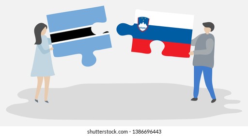 Couple holding two puzzles pieces with Motswana and Slovenian flags. Botswana and Slovenia national symbols together.