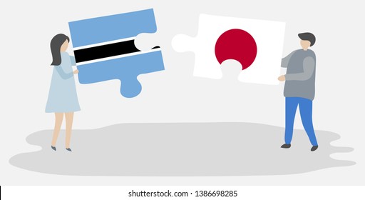 Couple holding two puzzles pieces with Motswana and Japanese flags. Botswana and Japan national symbols together.