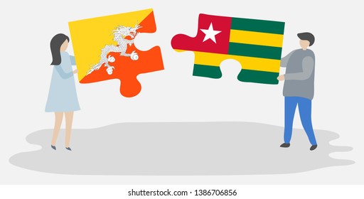 Couple holding two puzzles pieces with Bhutanese and Togolese flags. Bhutan and Togo national symbols together.