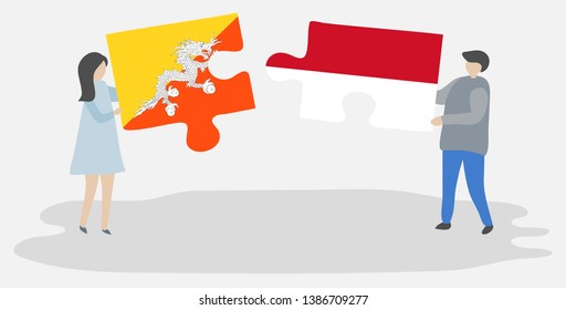 Couple holding two puzzles pieces with Bhutanese and Indonesian flags. Bhutan and Indonesia national symbols together.