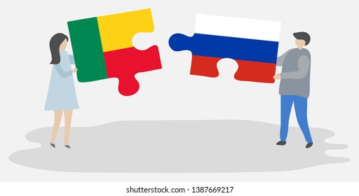 Couple holding two puzzles pieces with Beninese and Russian flags. Benin and Russia national symbols together.