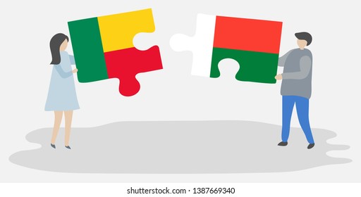 Couple holding two puzzles pieces with Beninese and Malagasy flags. Benin and Madagascar national symbols together.