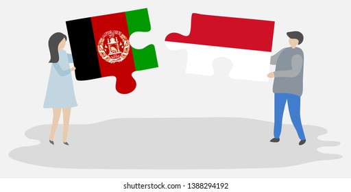 Couple holding two puzzles pieces with Afghan and Indonesian flags. Afghanistan and Indonesia national symbols together.