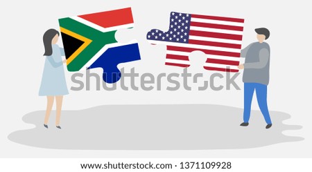 Couple holding two puzzles pieces with South African and American flags. South Africa and United States of America national symbols together.