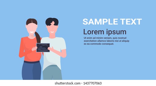 couple holding ultrasound scan of their baby future parents standing together happy family parenthood concept flat portrait horizontal