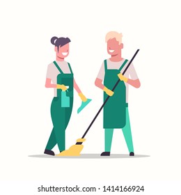 couple janitors man woman in uniform cleaning service concept cleaners holding mop and spray plastic bottle working together full length flat