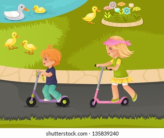Couple of kids riding push scooters in the park.