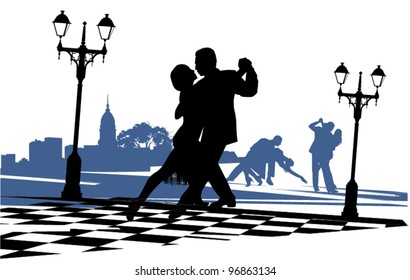 couple in love dancing tango on the area near the light