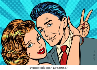 couple in love hugs victory gesture. Pop art retro vector illustration vintage kitsch